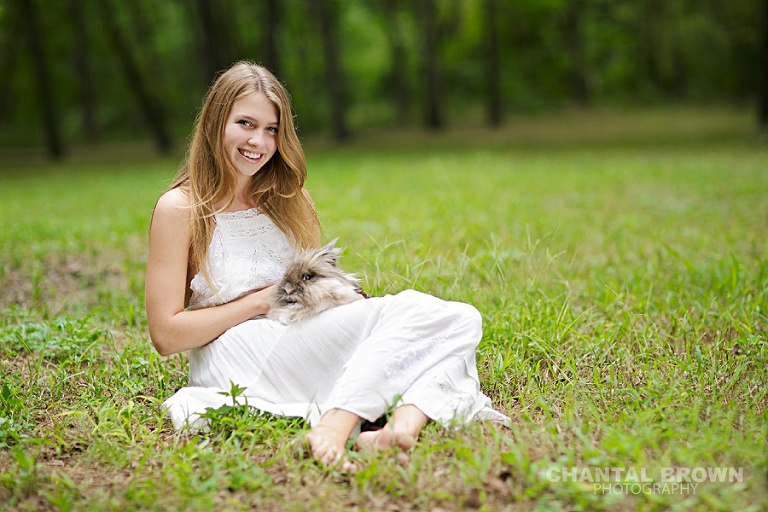 Senior pictures in Plano Texas holding a rabbit in the field by Chantal Brown Photography