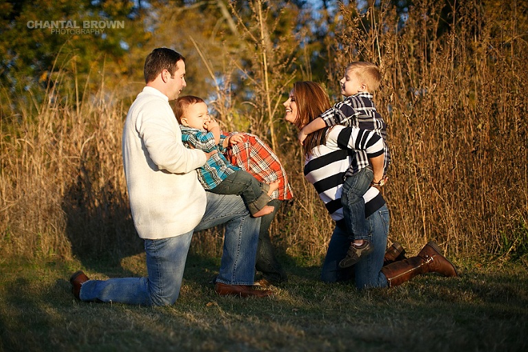 Children family playing in the sunset around tall grass by Chantal Brown Photography