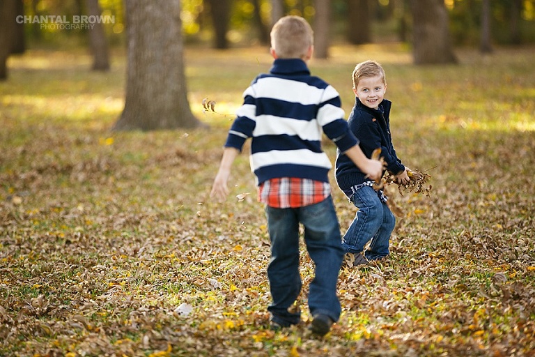 Children playing in autumn fall yellow leaves family pictures in Dallas Highland Park by Chantal Brown Photography