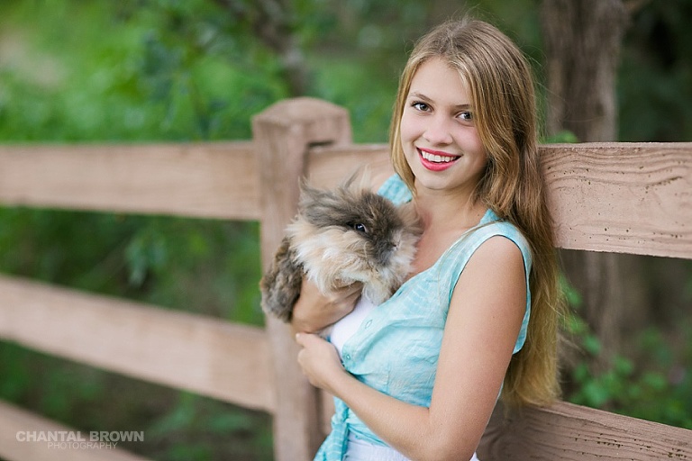 The best outdoor Addison TX senior portraits of Greenhill high school girl leaning on wall taken by Chantal Brown Photography of Dallas.