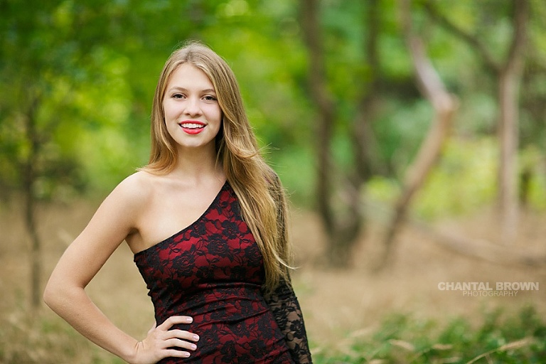 The best Addison Texas senior portrait photographer in Addison TX with a high school wearing pretty red dress in outdoor by Chantal Brown of Addison senior photographer.
