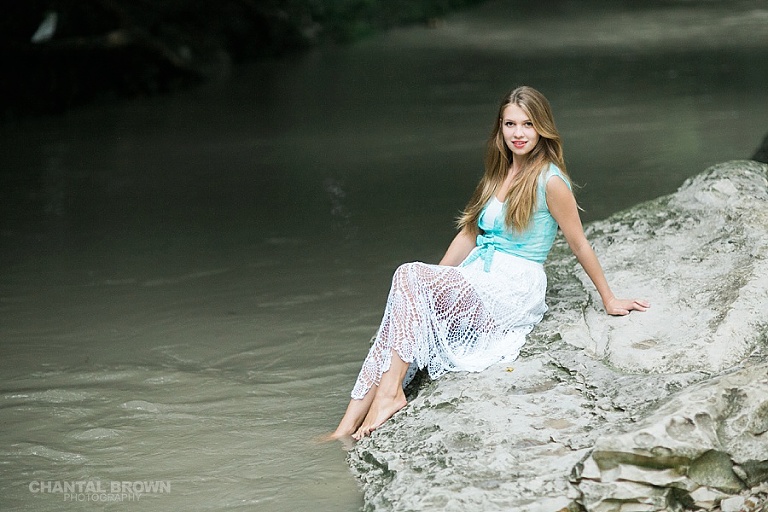 Sitting on white rock in the river senior portrait photographer in Addison TX by Chantal Brown