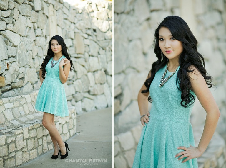 High school senior portraits standing next to pretty stone walls at Adriatica Village in McKinney TX taken by Chantal Brown.