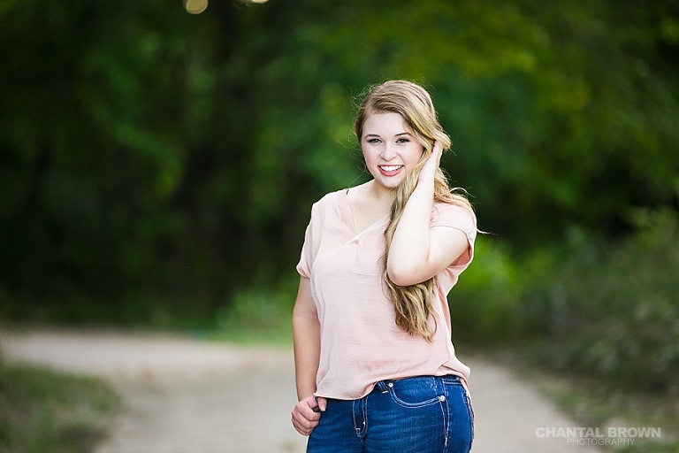 Stunning high school senior picture smiling taken at outdoor Breckinridge park by Dallas senior portrait photographer Chantal Brown.