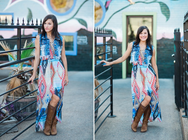 Deep Ellum senior pictures leaning on black metal fence and flower wall at Cafe Brazil in Dallas.