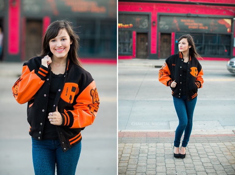 Deep Ellum senior pictures wearing Rockwall high school letterman jacket standing next to the red wall in Dallas Texas.