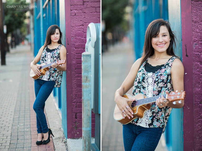 Senior Portraits in Deep Ellum Dallas TX holding a guitar by blue purple wall.