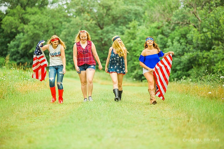 4th of July themed senior portraits group photo shoot in Dallas standing in big grass field taken by Chantal Brown Photography.