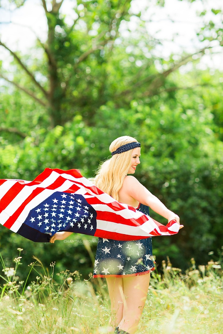 Holding the real American flag outdoor. All American high school by Chantal Brown Photography.