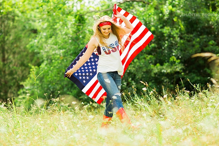 American flag senior portraits taken in Dallas of a Plano high school senior student. It was taken outdoor in a tall grass field wearing all American outfit. www.chantalbrownphotography.com