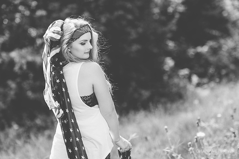Happy Independence Day picture in black and white of a Plano high school senior student holding an American flag scarf taken in Dallas by Chantal Brown Photography.