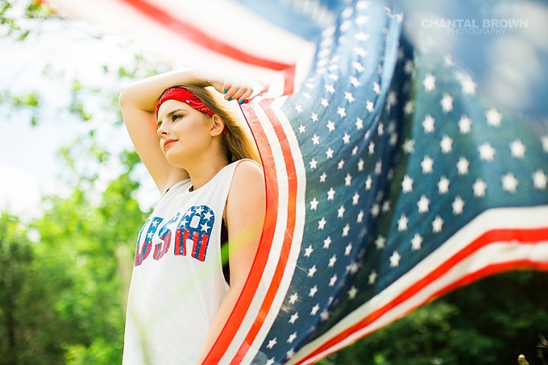 Happy Independence Day American Flag Dallas senior portraits holding a scarf outdoor field by Chantal Brown Photography. www.chantalbrownphotography.com