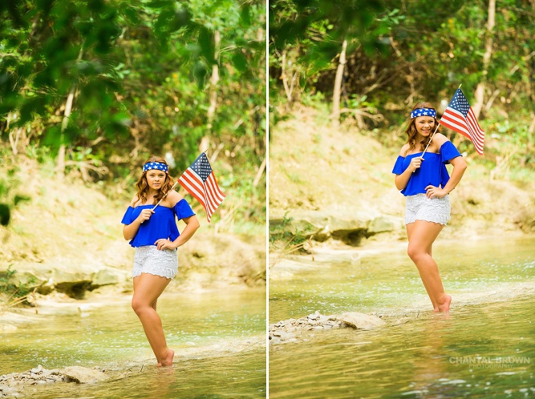 Very cute and patriotic outfit of a Dallas senior portraits and holding a small American flag standing in the water river creek outside. Taken by Dallas Chantal Brown Photography.