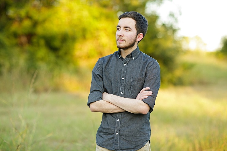 High school boy senior portraits in Plano Dallas in the field.